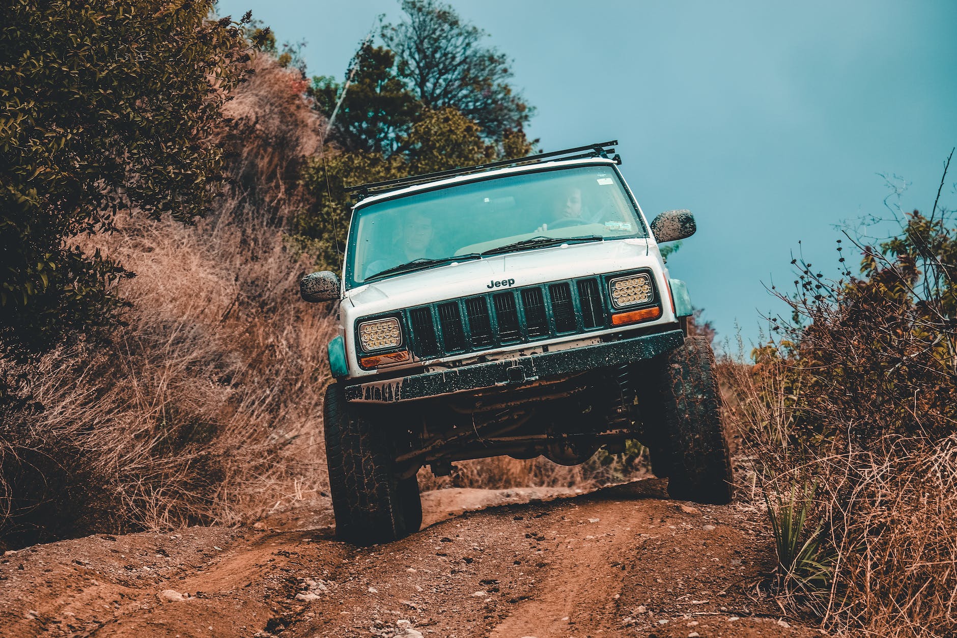 white jeep suv cruising down the road